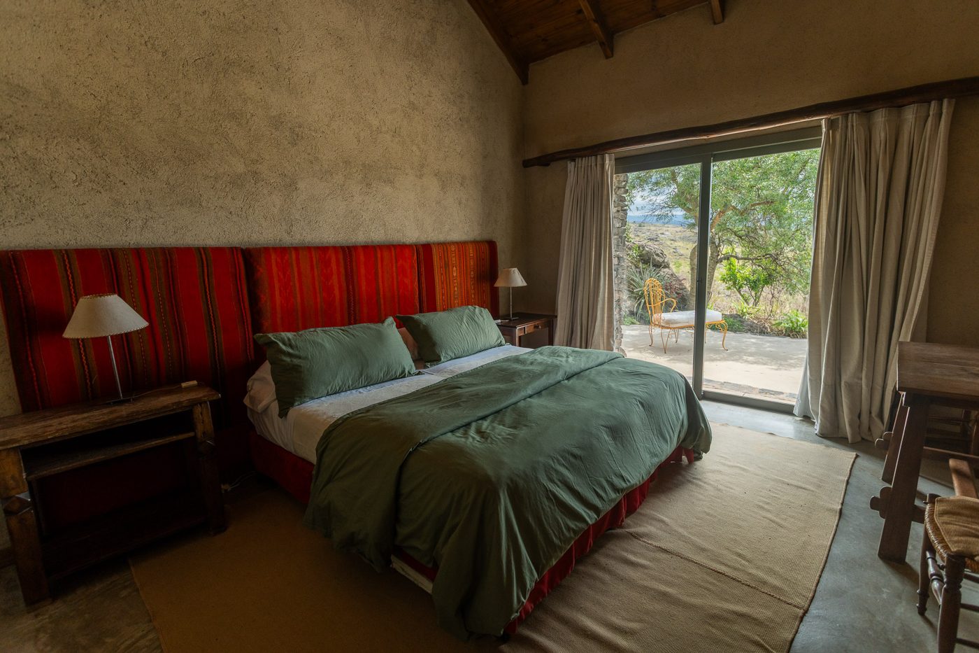 Bedroom opening onto its terrace and the hills