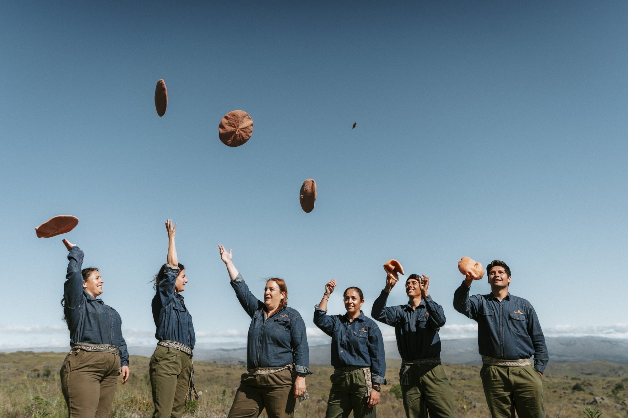 The Carahuasi team throwing their berets in the air