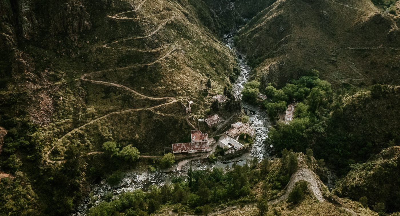 Pueblo Escondido in its valley, the tracks winding down