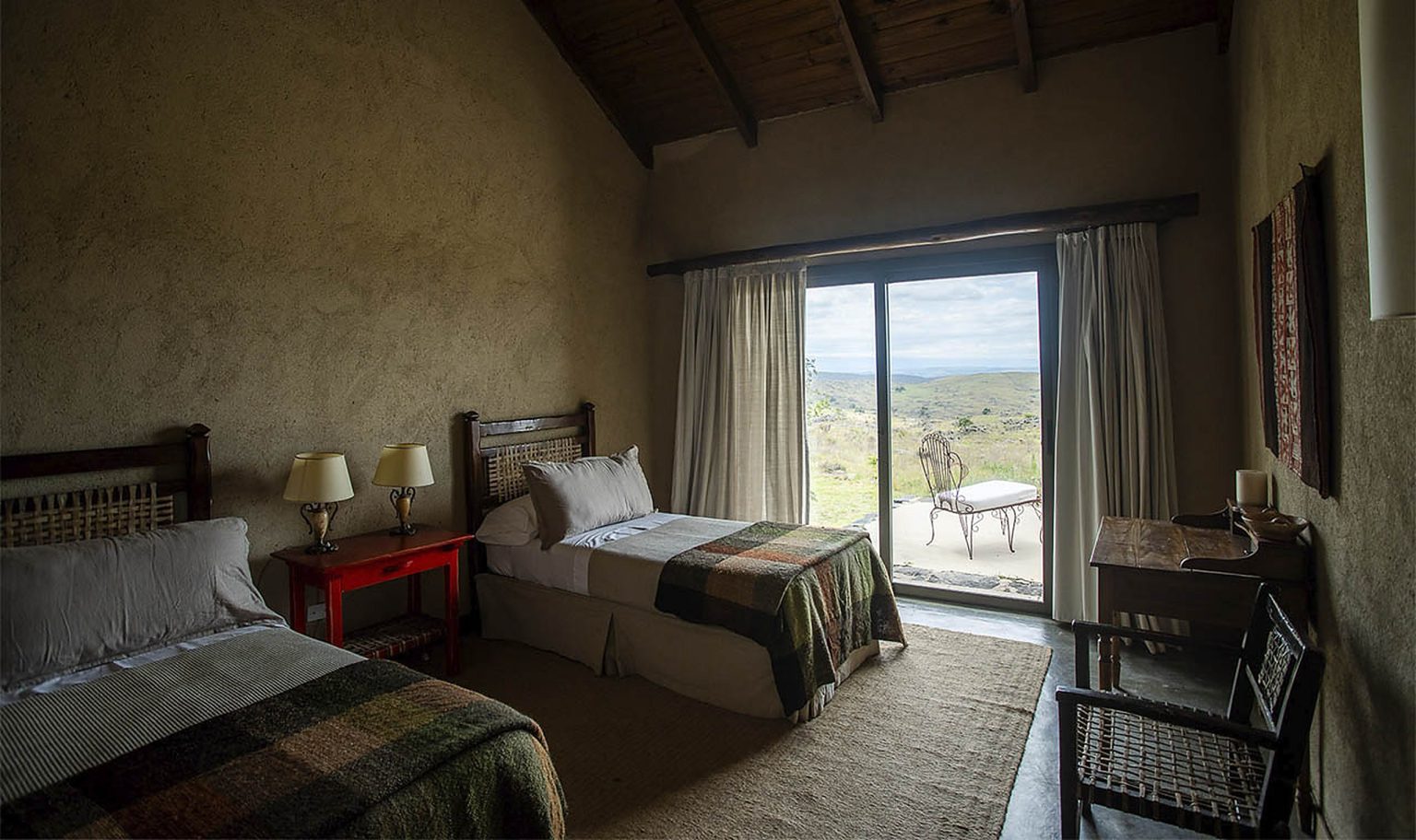 Module bedroom with twin beds opening to a view of the Sierras