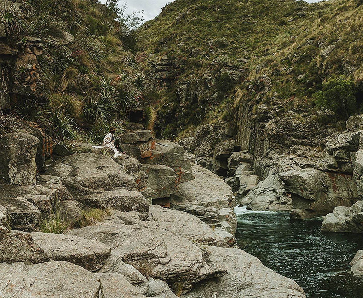 Sitting on the granite rocks above a deep river pool inside the property